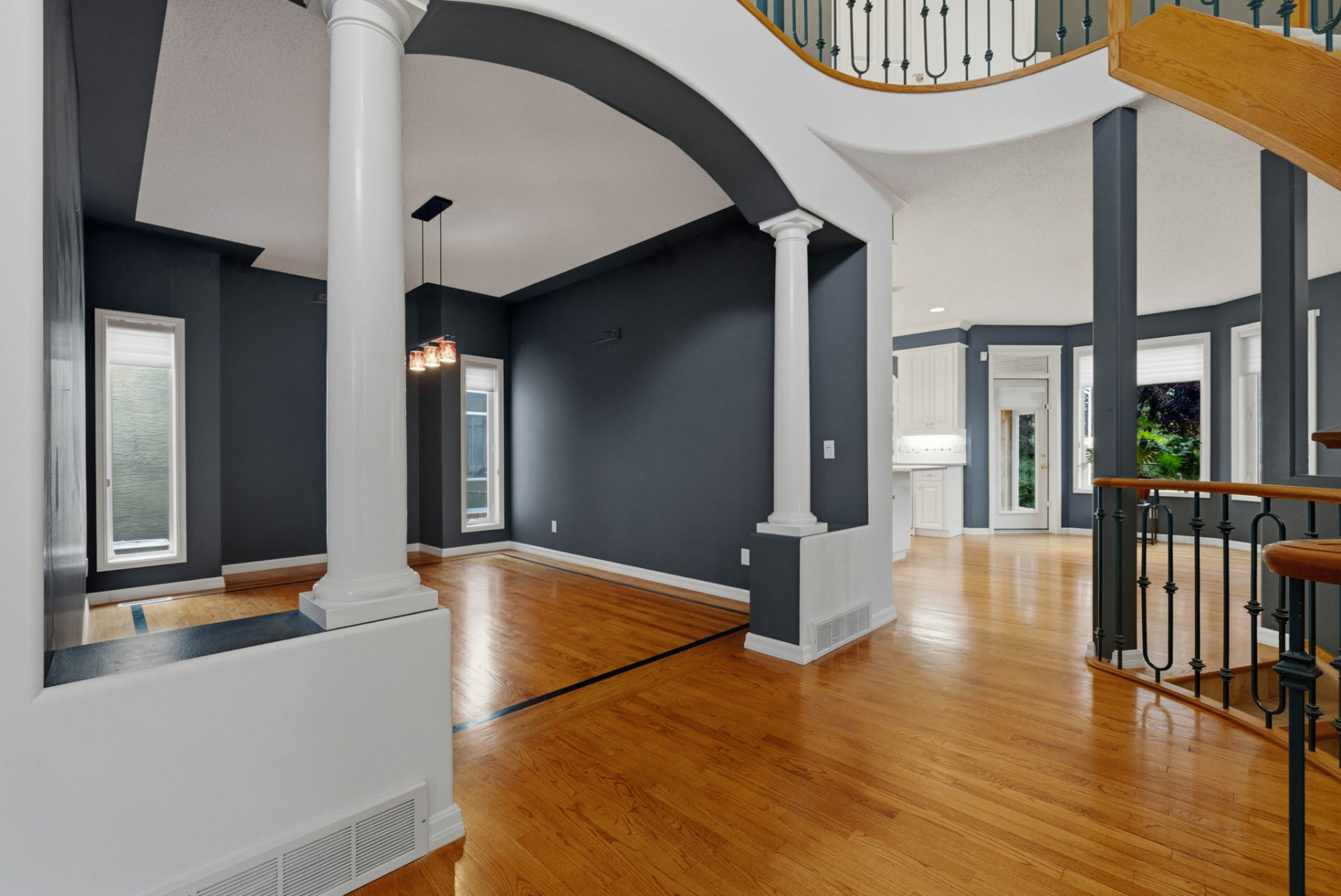 Formal dining room framed by columns and a sweeping archway